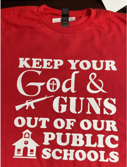 Photo of red shirt with white imprint that says "Keep your god and guns out of our public schools"