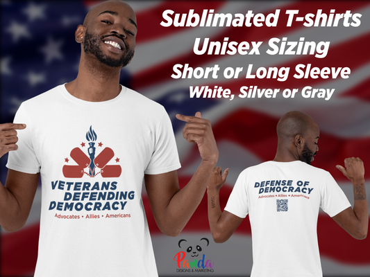 black man wearing white t-shirt with the Veterans Defending Democracy logo which features a hand holding a torch with 4 arching dog tags and stars and underneath the VDD logo is "Advocates. Allies. Americans" The logo is in navy blue and dark red.  The back featured the text version of  Defense of Democracy logo  and a QR code that takes scanners to defenseofdemocracy.org