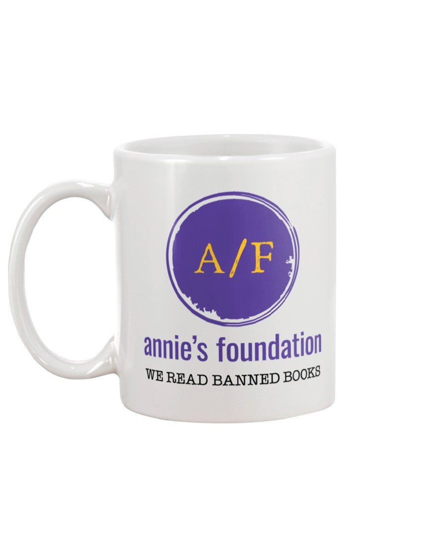 15 oz white ceramic sublimated mug with purple Annie's Foundation logo and We Read Banned Books