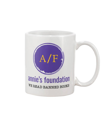 15 oz white ceramic sublimated mug with purple Annie's Foundation logo and We Read Banned Books