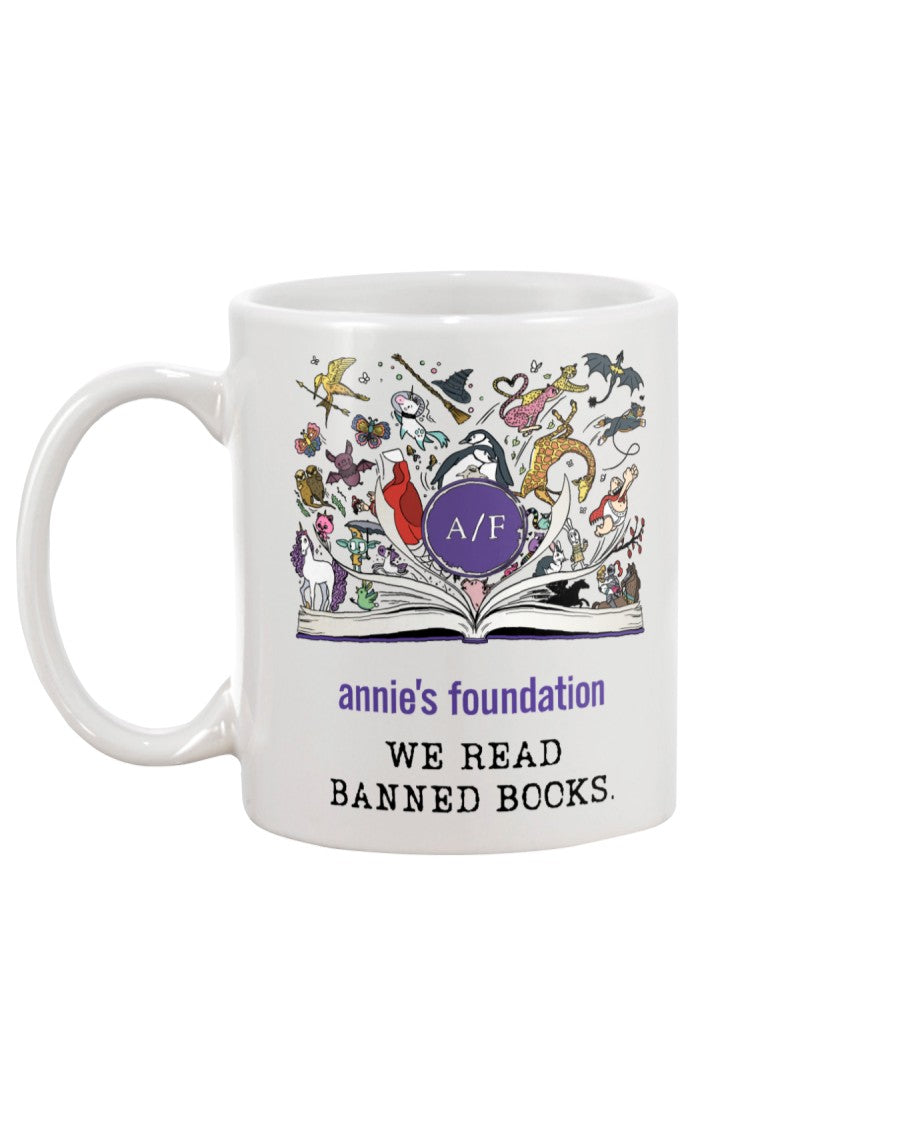 15 oz white ceramic mug with magical book artwork, Annie's Foundation logo and We Read Banned Books